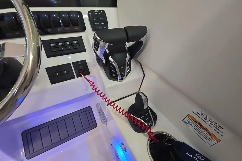 Slide: The Image of Control panel of 2026 Sailfish 276 DC boat with steering wheel and throttle. - 32