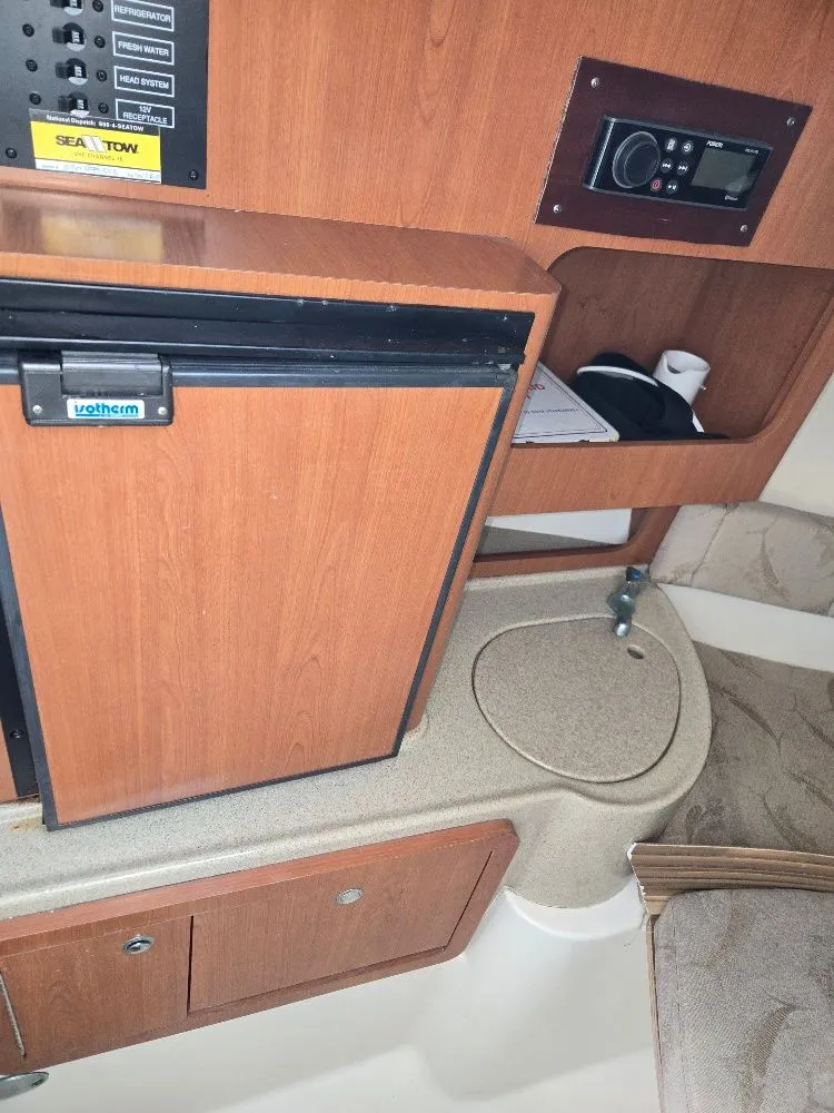 Slide: The Image of 2005 Hydra-Sports Vector 2500 VX cabin interior with fridge, sink, and control panel. - 16