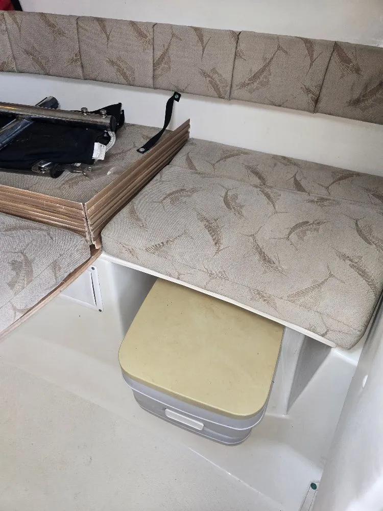 Slide: The Image of 2005 Hydra-Sports Vector 2500 VX cabin interior with cushioned seating and storage. - 18