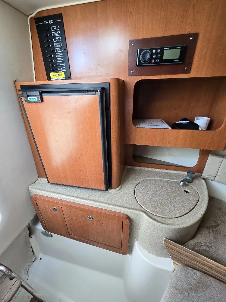 Slide: The Image of 2005 Hydra-Sports Vector 2500 VX cabin interior with fridge, sink, and control panel. - 19