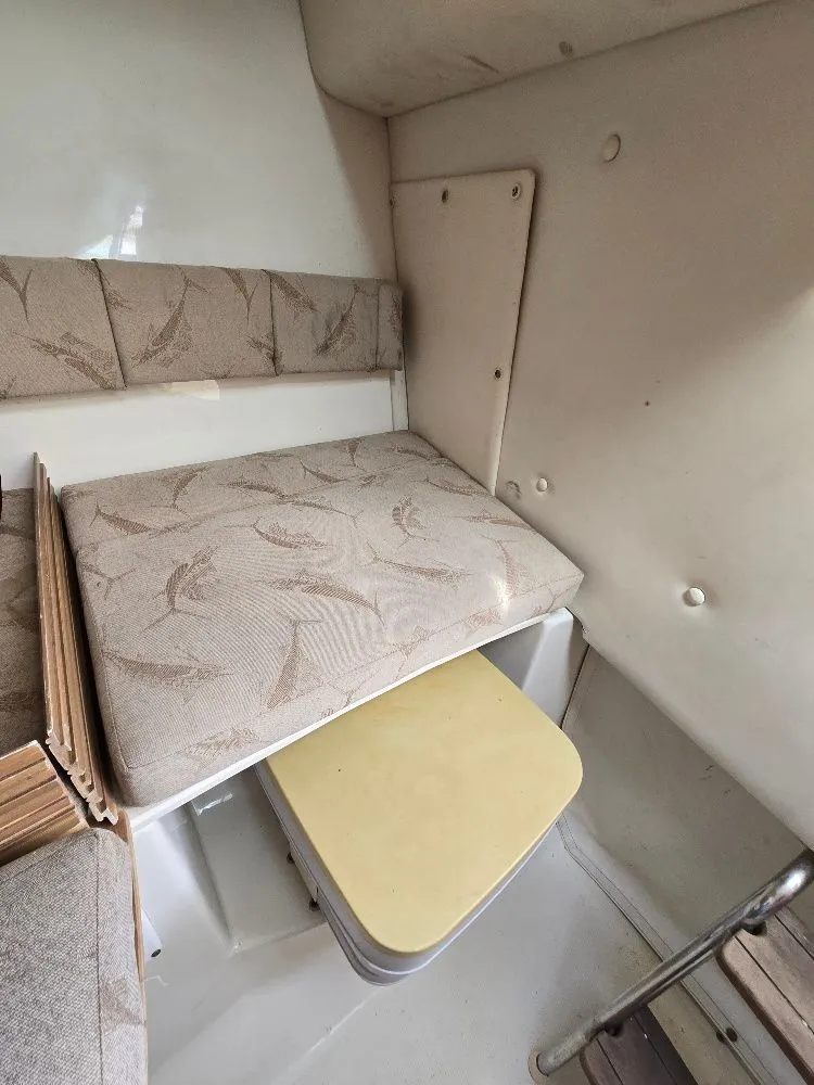 Slide: The Image of 2005 Hydra-Sports Vector 2500 VX cabin interior with cushioned seating and storage area. - 20