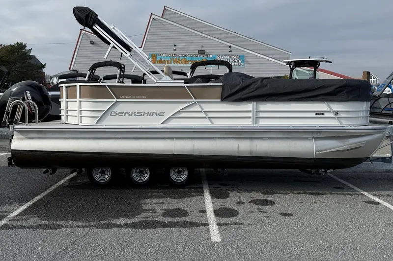 The Image of 2025 Berkshire 22CL CTS pontoon boat in parking lot, covered and ready for transport. - 0