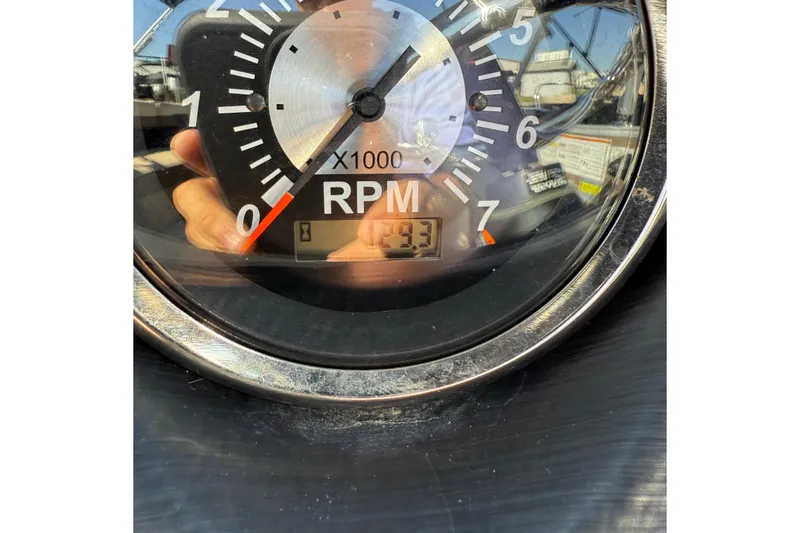 Slide: The Image of 2025 Berkshire 22CL CTS pontoon boat interior with beige seating and steering console. - 10