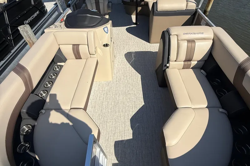 Slide: The Image of 2025 Berkshire 22CL CTS pontoon boat with canopy and outboard motor, parked outdoors. - 3