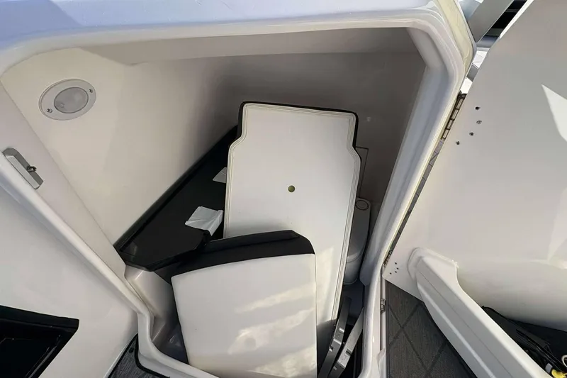 Slide: The Image of 2019 Yamaha 275 SE boat storage compartment with white interior and removable panels. - 11