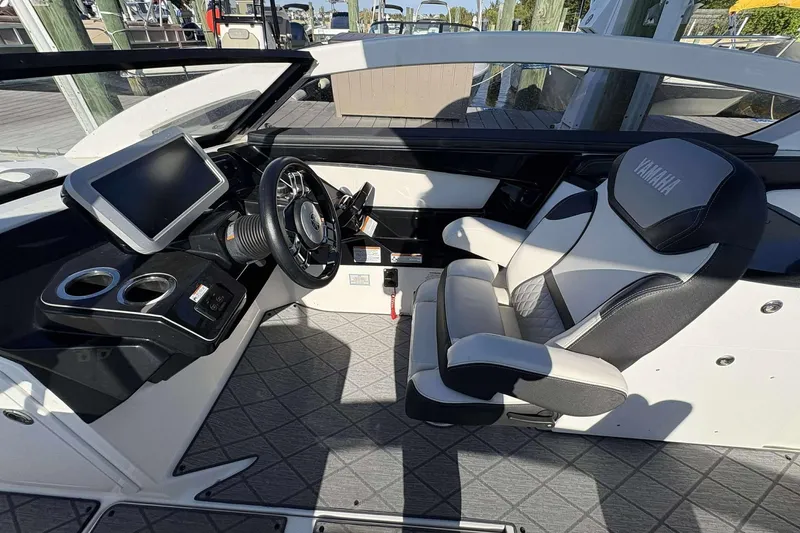 Slide: The Image of 2019 Yamaha 275 SE boat interior with steering wheel and touchscreen display. - 14