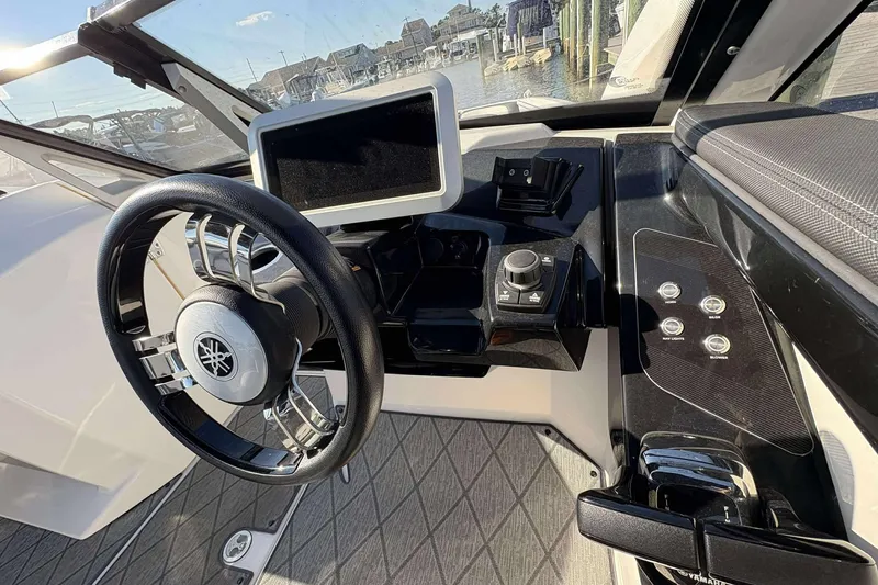 Slide: The Image of 2019 Yamaha 275 SE boat dashboard with steering wheel and control panel. - 15