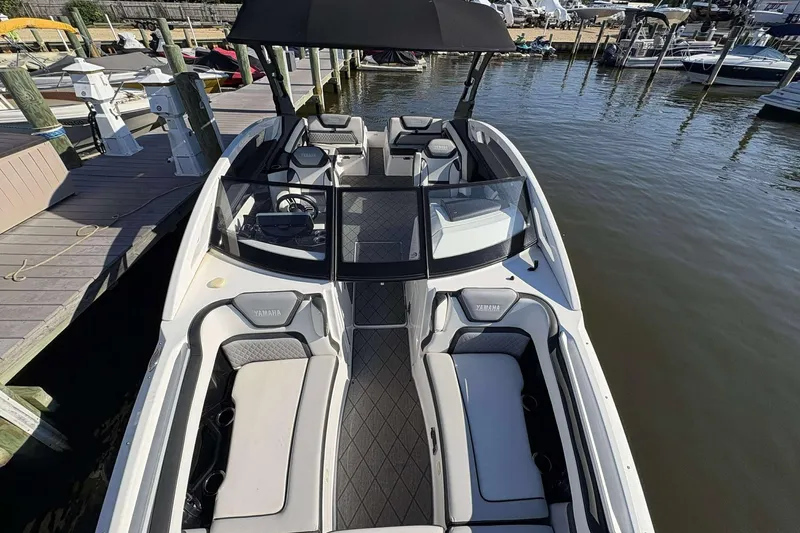 Slide: The Image of 2019 Yamaha 275 SE boat docked, featuring spacious seating and sleek design. - 17