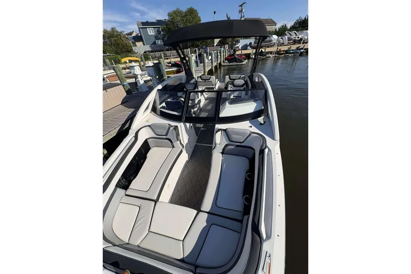 Slide: The Image of 2019 Yamaha 275 SE boat docked, featuring spacious seating and sleek design. - 18