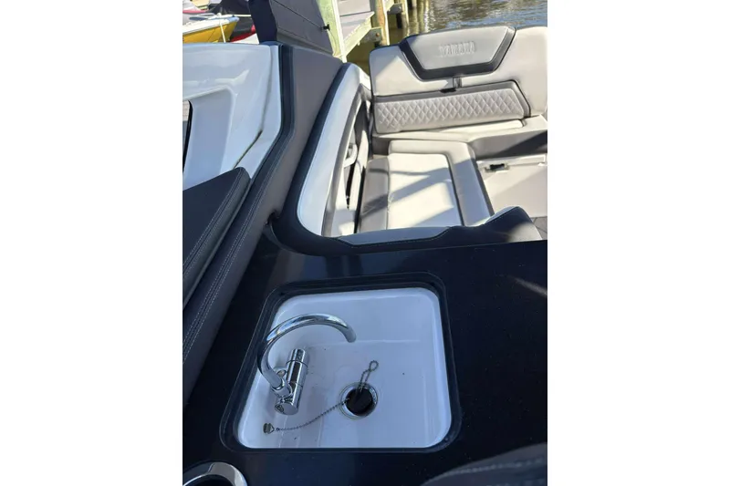 Slide: The Image of 2019 Yamaha 275 SE boat interior with sink and seating area. - 23