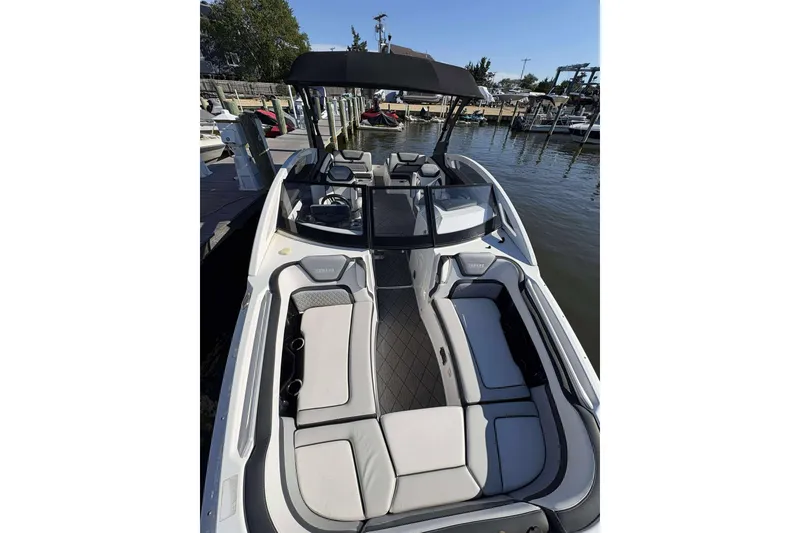Slide: The Image of 2019 Yamaha 275 SE boat with sleek interior design docked at marina. - 3