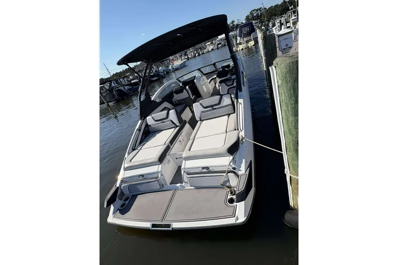 Slide: The Image of 2019 Yamaha 275 SE boat docked at marina, featuring spacious seating and sleek design. - 5