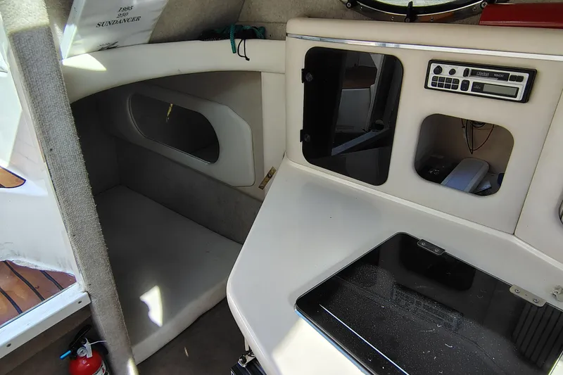 Slide: The Image of Interior cabin of a 1995 Sea Ray 250 Sundancer boat, featuring a compact kitchenette. - 19
