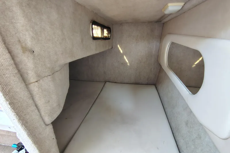Slide: The Image of Interior cabin of a 1995 Sea Ray 250 Sundancer boat, featuring cozy sleeping quarters. - 20