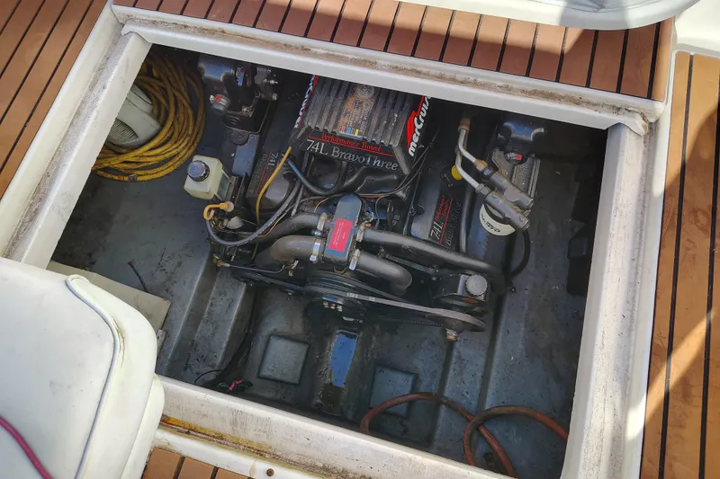 Slide: The Image of Engine compartment of a 1995 Sea Ray 250 Sundancer boat, featuring a MerCruiser 7.4L engine. - 26