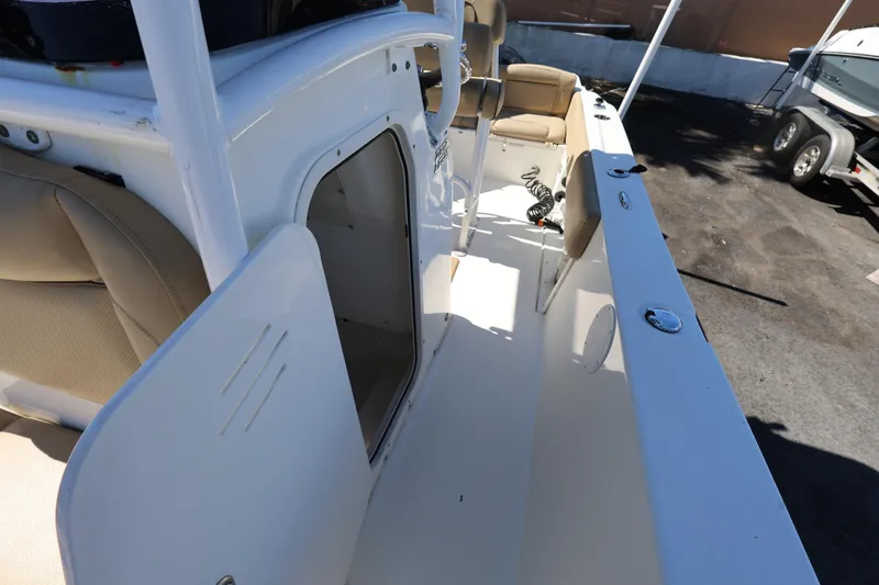 Slide: The Image of 2019 NauticStar 2302 Legacy boat interior with open storage compartment. - 11