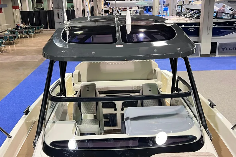 Slide: The Image of Navan S30 2026 boat interior at a boat show, featuring modern seating and sleek design. - 14