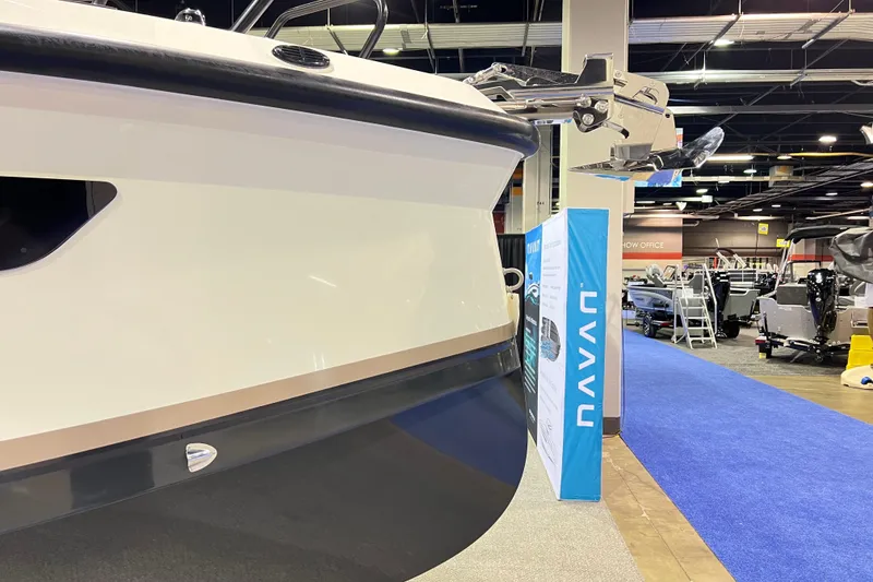 Slide: The Image of 2026 Navan S30 boat displayed at an indoor exhibition with blue carpet. - 2