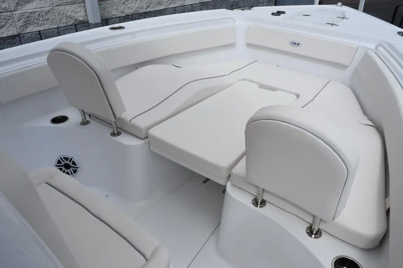 Slide: The Image of 2026 Sea Hunt Ultra 265 SE boat interior with white cushioned seating. - 12