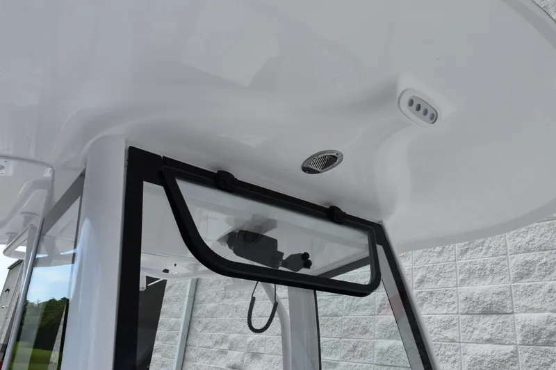 Slide: The Image of 2026 Sea Hunt Ultra 265 SE boat interior detail with window and ceiling features. - 14