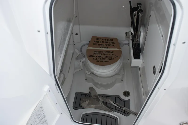 Slide: The Image of 2026 Sea Hunt Ultra 265 SE boat interior with toilet and protective film. - 15