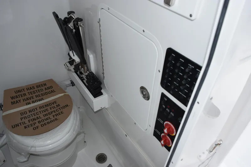 Slide: The Image of 2026 Sea Hunt Ultra 265 SE boat interior with toilet and control panel. - 16