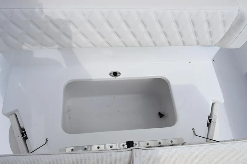 Slide: The Image of Interior view of 2026 Sea Hunt Ultra 265 SE boat with white seating and storage compartment. - 18
