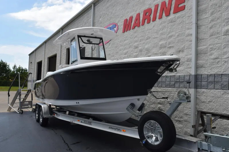 Slide: The Image of 2026 Sea Hunt Ultra 265 SE boat on trailer outside marine dealership. - 2