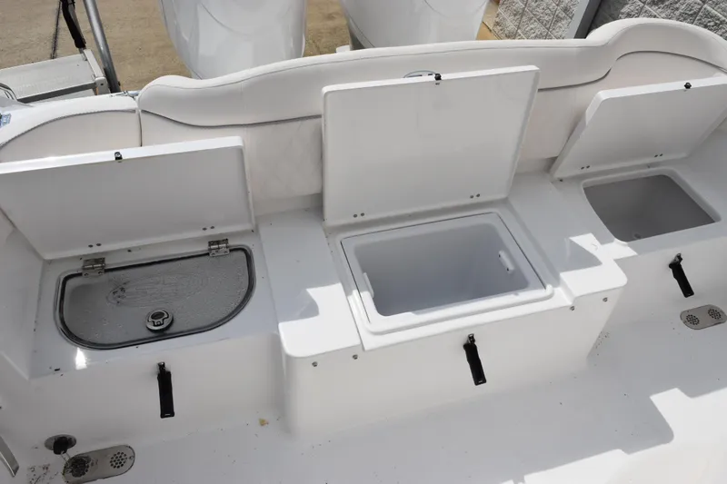 Slide: The Image of 2026 Sea Hunt Ultra 265 SE boat storage compartments with open lids. - 20