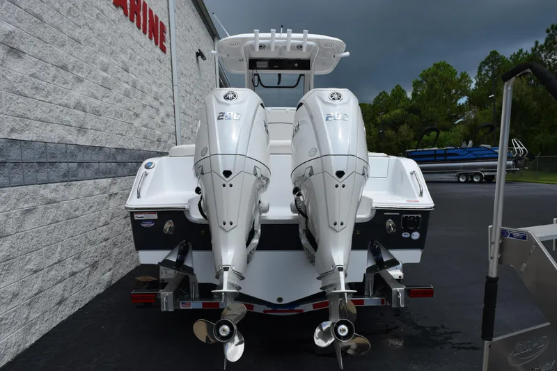 Slide: The Image of 2026 Sea Hunt Ultra 265 SE boat with dual Yamaha outboard engines, parked outdoors. - 4