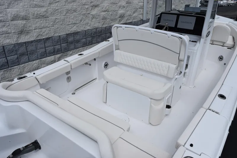 Slide: The Image of 2026 Sea Hunt Ultra 265 SE boat interior with white seating and Garmin displays. - 6