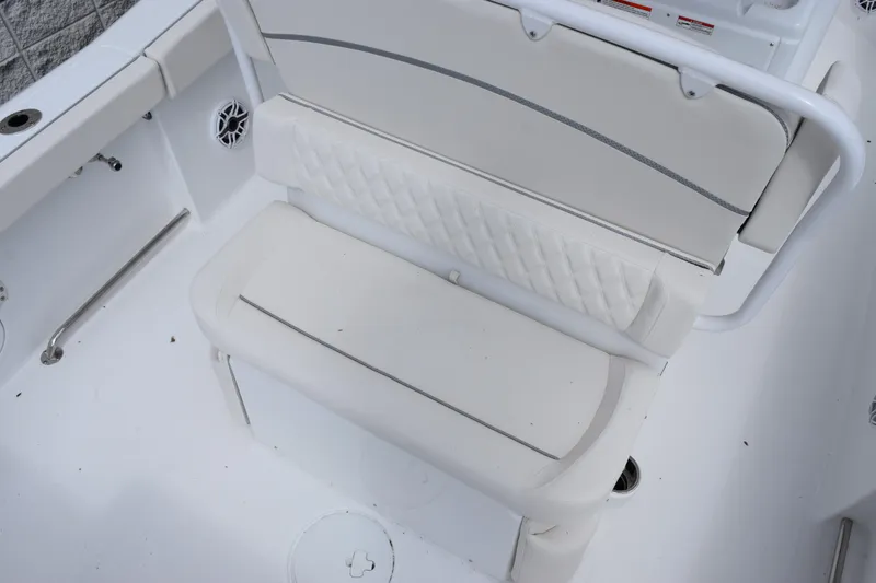 Slide: The Image of 2026 Sea Hunt Ultra 265 SE boat seating with white cushioned bench and backrest. - 7