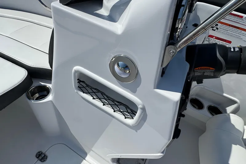 Slide: The Image of 2026 Stingray 172 SC boat interior with cup holder and storage net. - 10