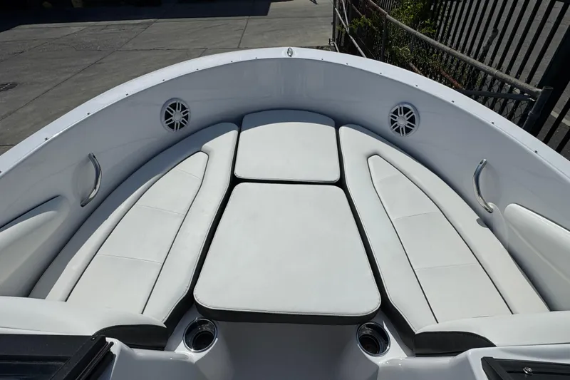 Slide: The Image of 2026 Stingray 172 SC boat interior with white cushioned seating and stainless steel handles. - 11