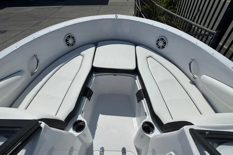 Slide: The Image of 2026 Stingray 172 SC boat interior with white cushioned seating and cup holders. - 12