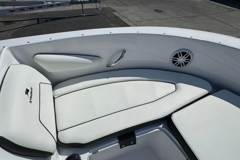 Slide: The Image of 2026 Stingray 172 SC boat interior with white cushioned seating and speaker. - 13