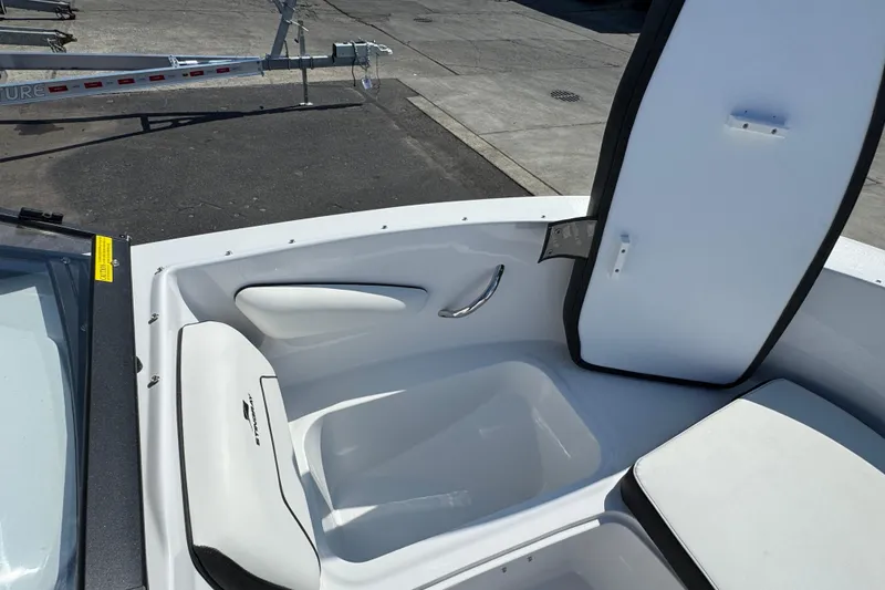 Slide: The Image of 2026 Stingray 172 SC boat interior with open storage compartment and seating. - 15