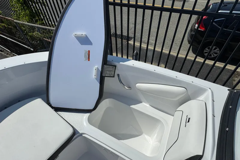 Slide: The Image of 2026 Stingray 172 SC boat interior with open storage compartment and seating. - 16