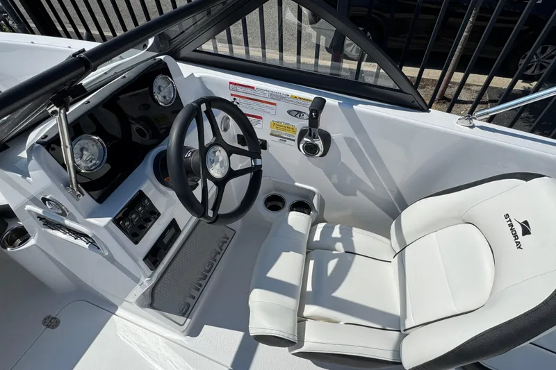 Slide: The Image of 2026 Stingray 172 SC boat interior with steering wheel and white seating. - 3