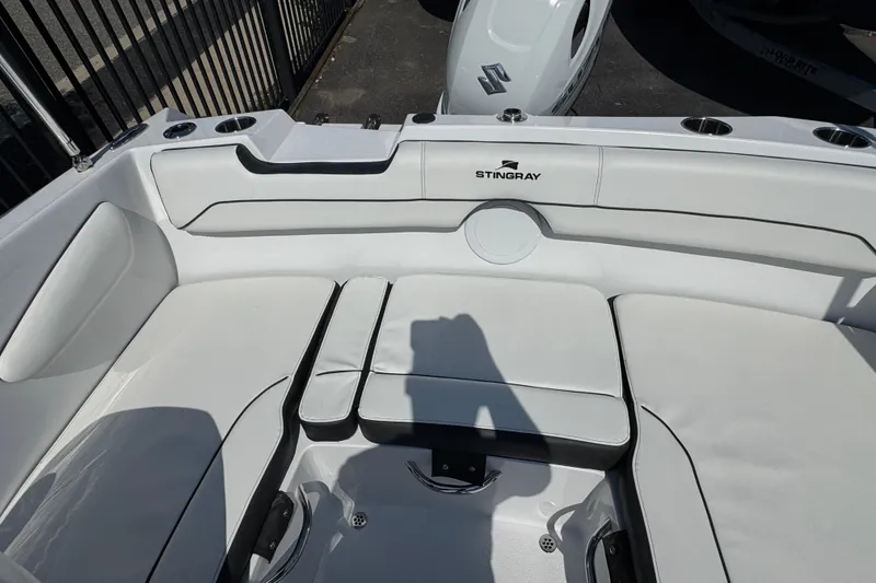 Slide: The Image of 2026 Stingray 172 SC boat interior with white cushioned seating and cup holders. - 5