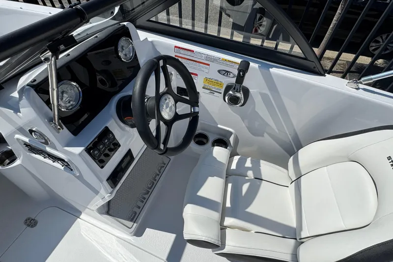 Slide: The Image of 2026 Stingray 172 SC boat interior with steering wheel and white seating. - 8