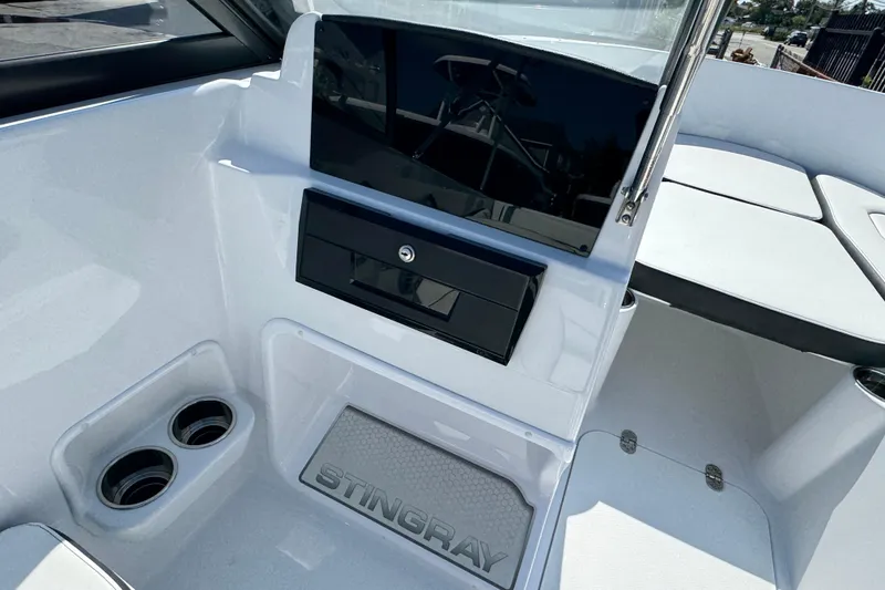 Slide: The Image of 2026 Stingray 172 SC boat interior with cup holders and storage compartment. - 9