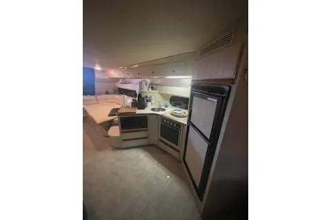 Slide: The Image of 1990 Carver 34-38 yacht interior kitchen with modern appliances and cozy design. - 11