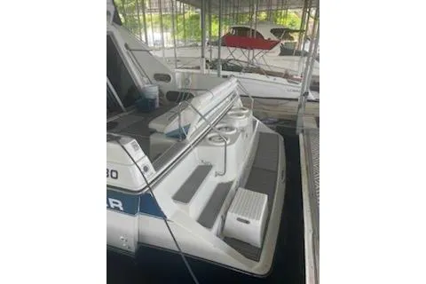 Slide: The Image of 1990 Carver 34-38 boat docked, featuring rear deck and seating area. - 18