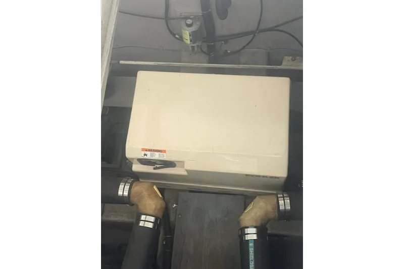 Slide: The Image of 1990 Carver 34-38 engine compartment with generator and hoses. - 22