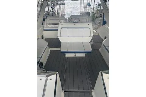 Slide: The Image of 1990 Carver 34-38 boat interior with white seating and gray flooring. - 19