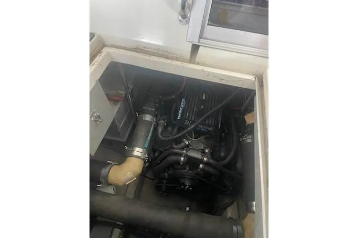 Slide: The Image of Engine compartment of a 1990 Carver 34 - 38 boat, showcasing mechanical components. - 23