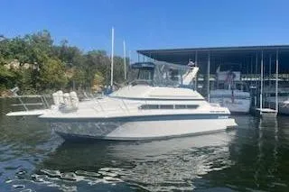 Slide: The Image of 1990 Carver 34-38 yacht docked at marina under clear blue sky. - 6