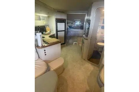 Slide: The Image of Interior of a 1990 Carver 34-38 yacht, featuring kitchen and living area. - 8