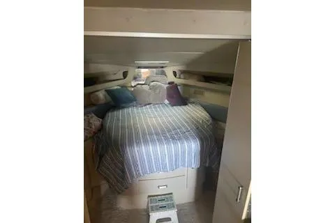 Slide: The Image of Cozy cabin interior of a 1990 Carver 34 - 38 boat with striped bedding. - 9